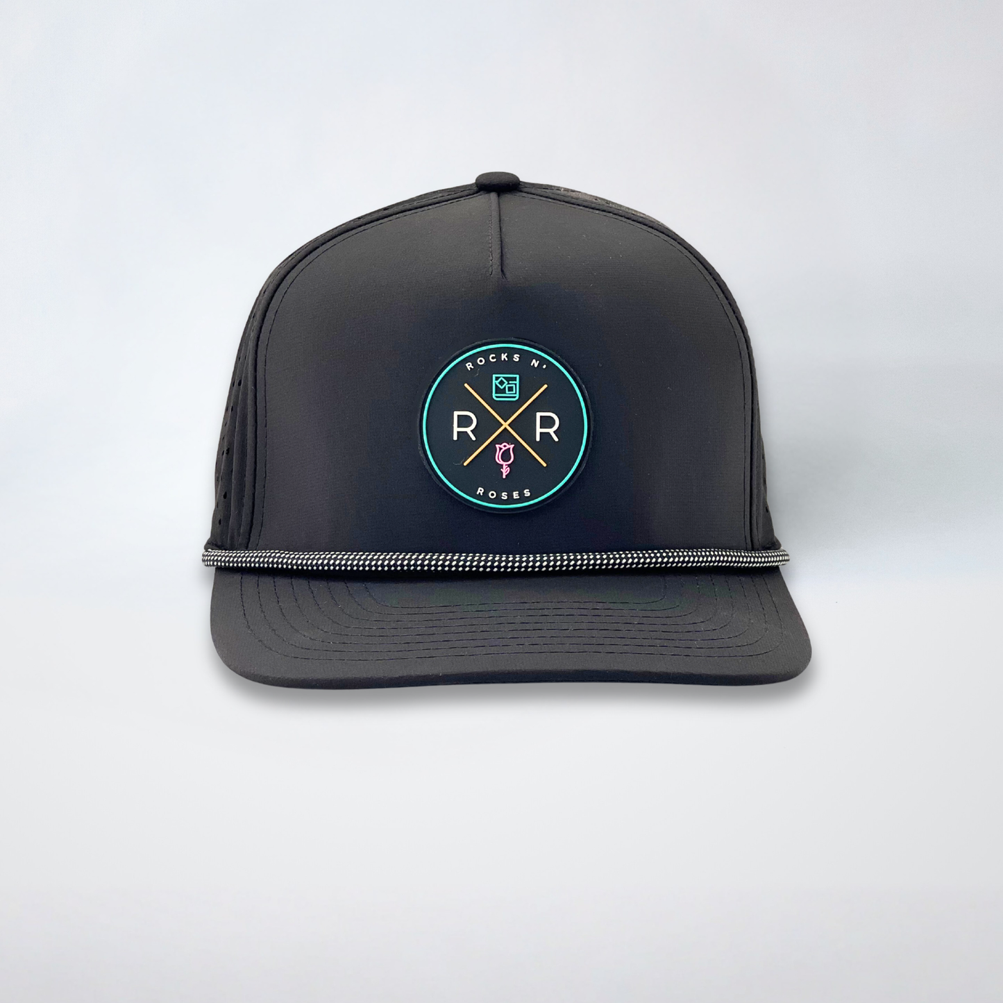 Image of a black golf hat made from polyester with a teal, pink, and gold rubber Rocks N' Roses logo and a black and white gridline rope accent.