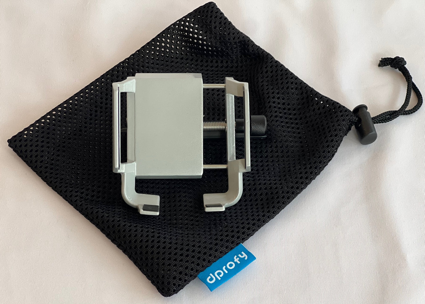 Image of the Dprofy magnet golf cart phone holder. It adjusts to any size smart phone using the black knob and comes with a mesh carrying case for storage in between rounds.