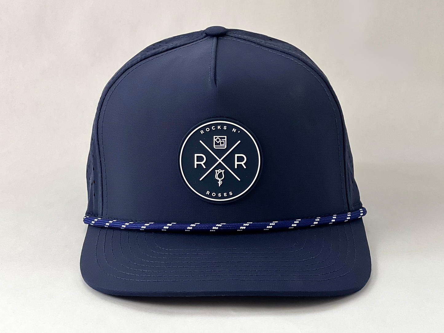 Rocks N' Roses Polyester Navy Blue Golf Hat featuring a navy blue and white rubber logo and navy blue and white decorative rope.