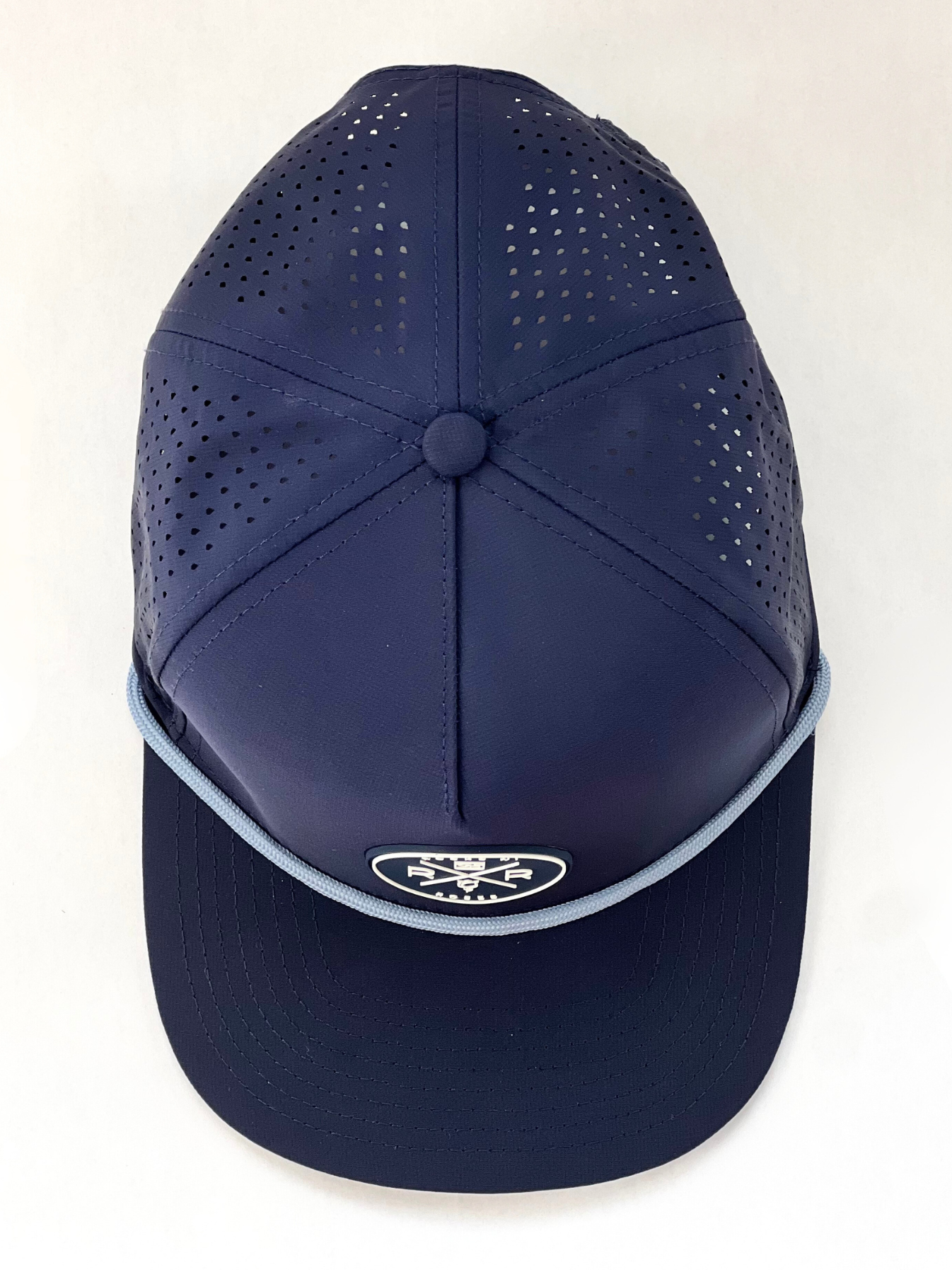 Rocks N' Roses Polyester Navy Blue Golf Hat overhead photograph showing laser perforated back panels, navy blue and white rubber logo, and solid light blue decorative rope.