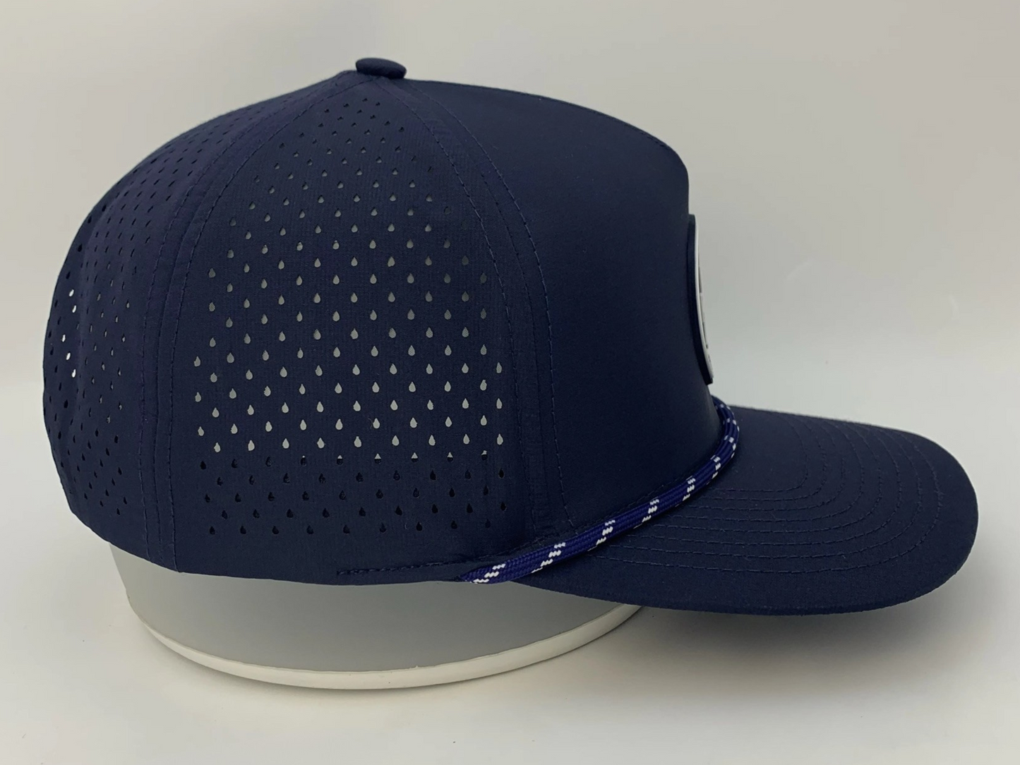 Rocks N' Roses Polyester Navy Blue Golf Hat showing laser perforated panels that deliver maximum breathability and navy blue and white decorative rope.
