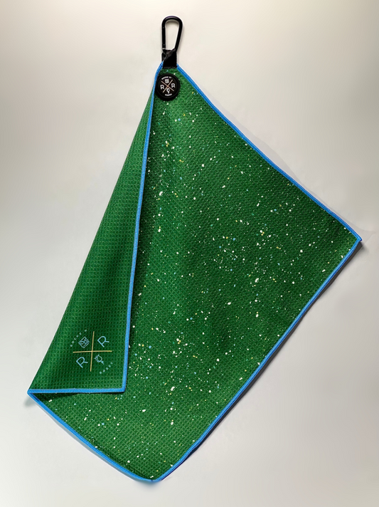 Photograph of Rocks N' Roses green paint splatter magnetic golf towel. This magnetic golf towel attaches to your golf cart for easy access and can be picked up greenside with your clubhead.
