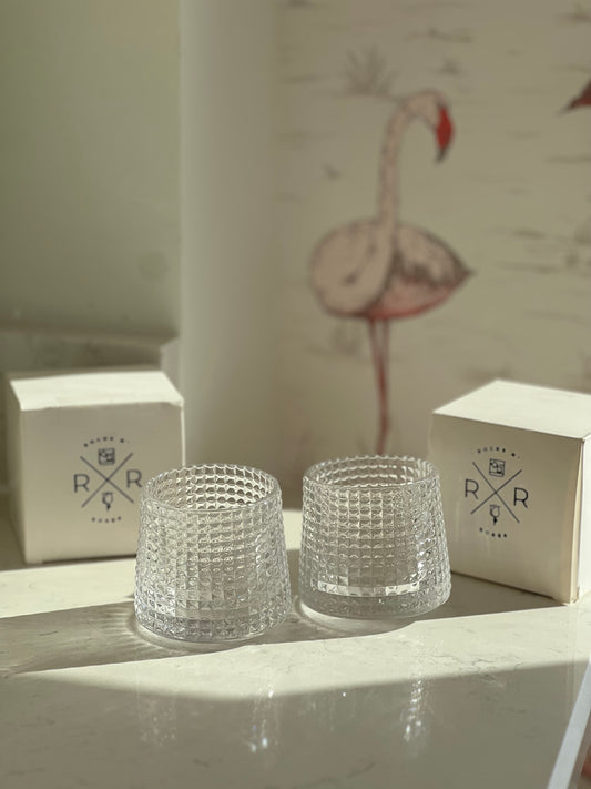 Image of the Rocks N' Roses spinning bourbon glasses. These glasses are very thick and have a diamond shaped repeating pattern. Simply spin and pour in your bourbon aerating the drink and brining out the fullest flavors.