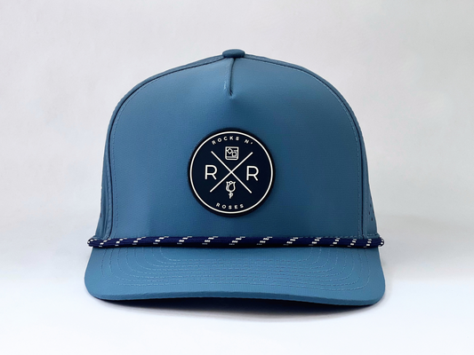 Rocks N' Roses Polyester Blue Steel Golf Hat featuring a navy blue and white rubber logo as well as a navy blue and white decorative rope.