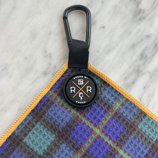 Close up shot of the Rocks N' Roses magnetic golf towel in a tartan plaid pattern. Close up shows the magnet and carabiner for attaching to your golf bag or golf cart.