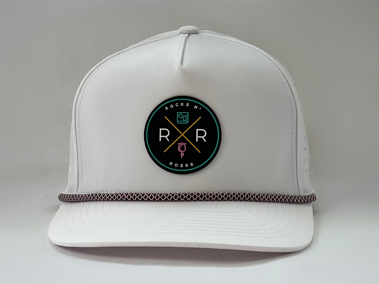 White golf hat made of performance polyester that is water resistant featuring a teal, pink, gold and black rubber logo and pink and black accent rope.