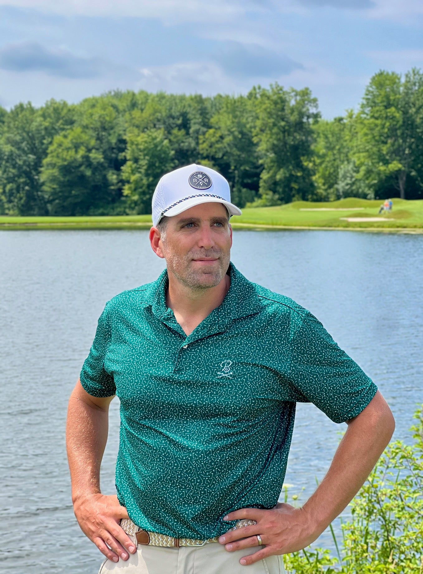 Man in white Rocks N' Roses Performance Golf Hat with rubber logo and green, white, and black rope.
