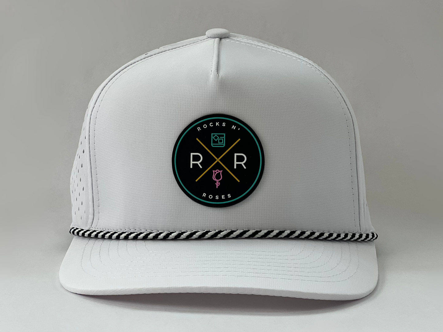 White golf hat made of performance polyester that is water resistant featuring a teal, pink, gold and black rubber logo and black and white accent rope.