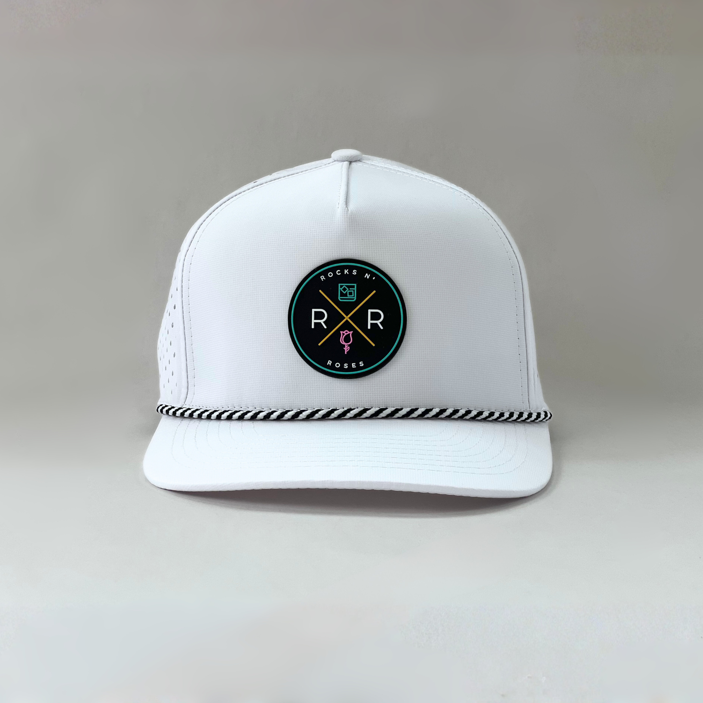 White golf hat made of performance polyester that is water resistant featuring a teal, pink, gold and black rubber logo and black and white accent rope.