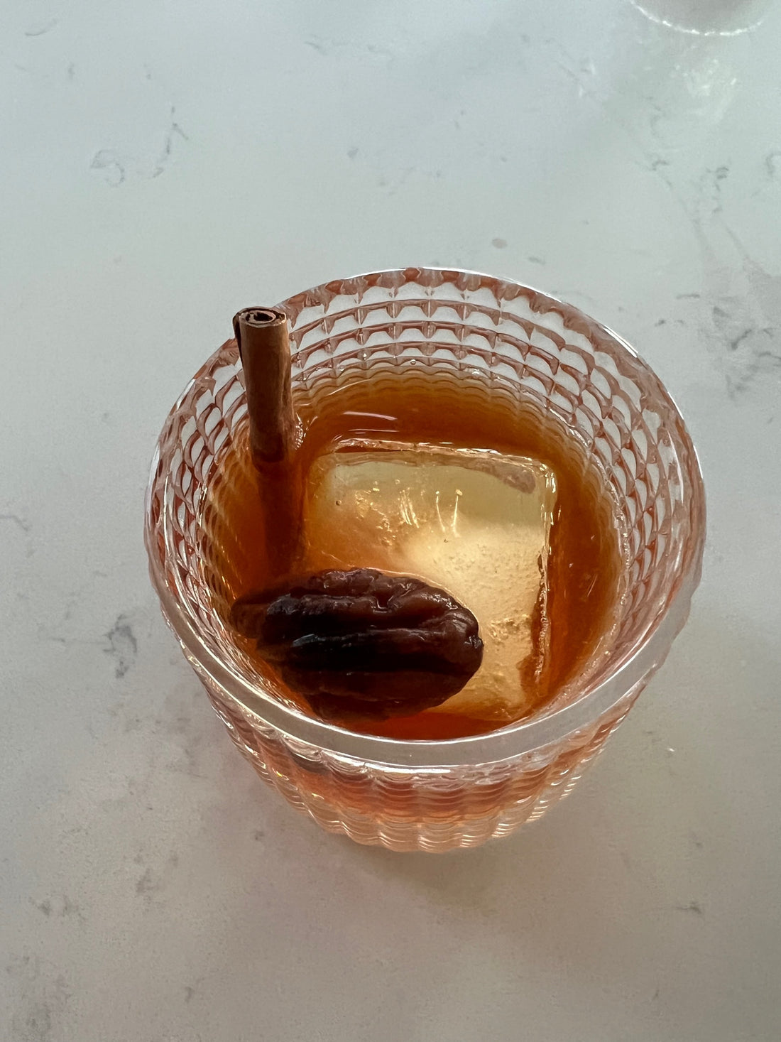 Photo of a cinnamon pecan Old Fashion in a Rocks N' Roses spinning bourbon glass.