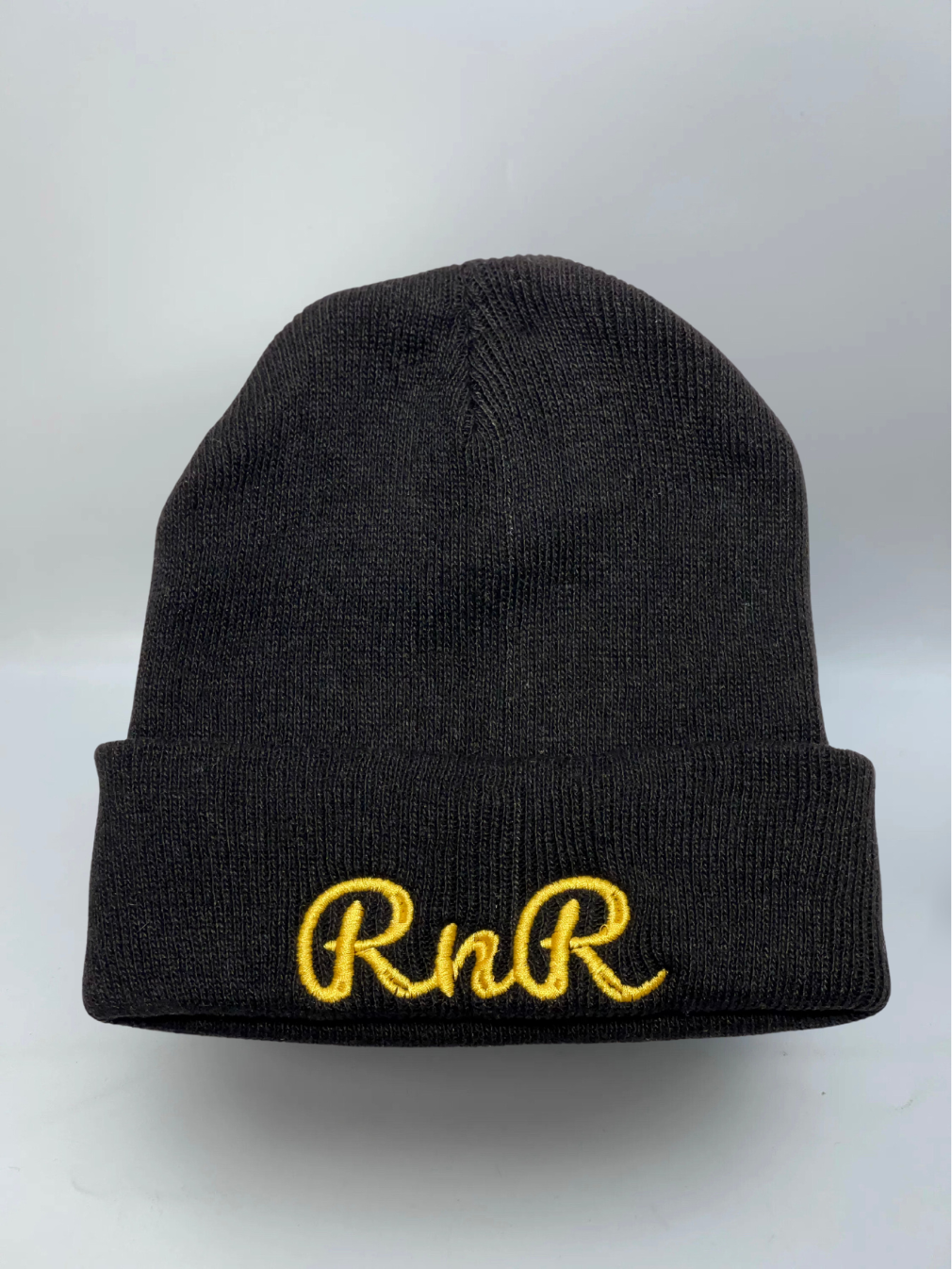 Rocks N' Roses black golf beanie featuring the Rocks N' Roses cursive RNR embroidered logo in gold.