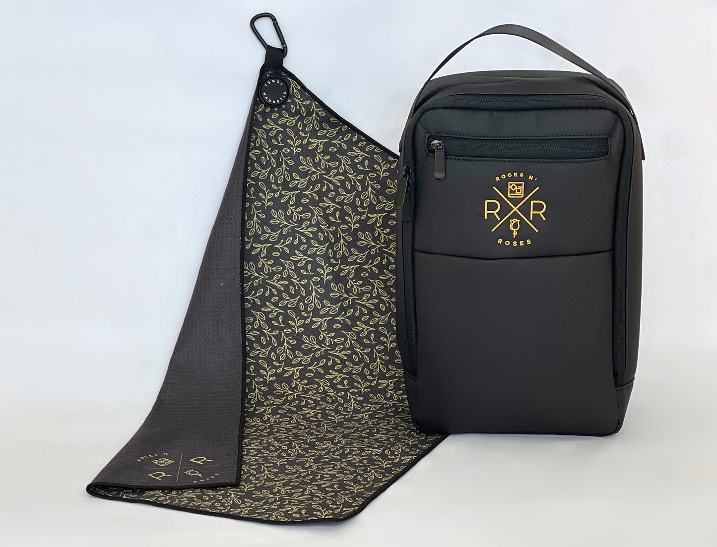 Image of the Rocks N' Roses Magnetic Golf Towel and Shoe Bag Bundle featuring a black golf shoe bag and gold and black floral magnetic golf towel.