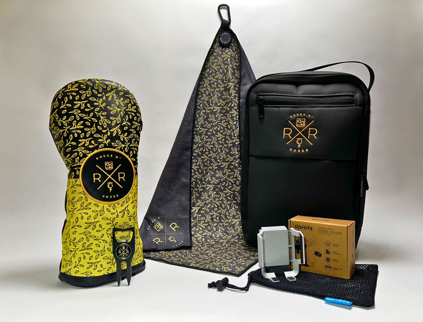 Image of the Rocks N' Roses Golf Gift Set Bag. This golf gift set features a gold and black floral PU driver headcover, black and golf magnetic golf towel, black and gold divot tool, dprofy magnetic golf cart phone holder all packed in the water resistant Rocks N' Roses shoe bag. Perfect for golf outings and country club tournament gifts.