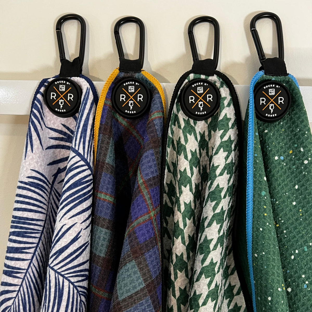 Image of the Rocks N' Roses Magnetic Golf towel collection showing 4 unique designs and close-up of the rubber molded magnet.