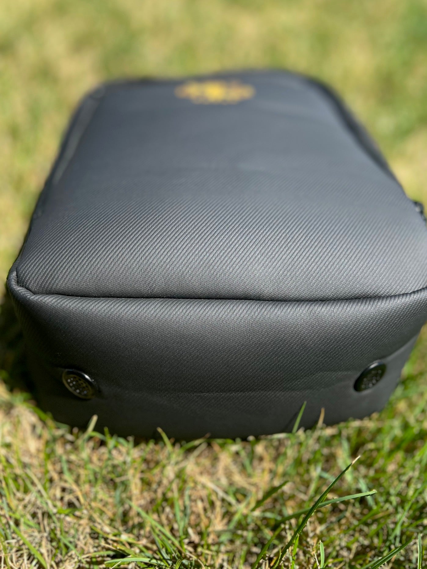 An image of the bottom of the black colored waterproof Rocks N' Roses shoe bag that feature to ventilation ports to air out stinky shoes.