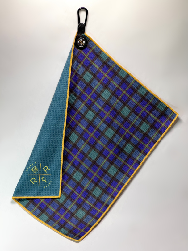 photograph of the Rocks N' Roses magnetic golf towel in a blue, green, and yellow tartan plaid pattern on the front side. The back of the towel is team with matching yellow Rocks N' Roses logo. Also, features a magnet for easy attachment to your golf cart or to pick up using your clubhead.
