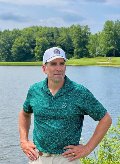 Man in white Rocks N' Roses Performance Golf Hat with rubber logo and green, white, and black rope.