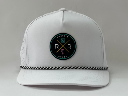 White golf hat made of performance polyester that is water resistant featuring a teal, pink, gold and black rubber logo and black and white accent rope.