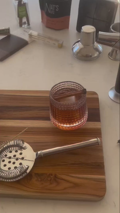How to video showing how to make a Pecan Infused Old Fashioned cocktail using Nat's Nuts Cinnamon Whiskey Pecans, the, Rocks N' Roses Spinning Whiskey Bourbon Glass and Yes Cocktail Company's Old Fashioned infused sugar cubes.