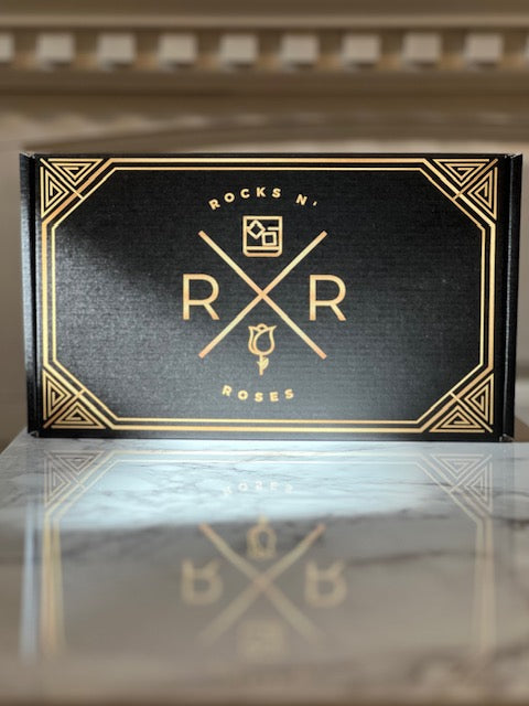 Picture of the Rocks N' Roses Bourbon Box shipper. This box has a classic art deco design on both the inside and outside of the box. The Bourbon Box also comes with the items protected in matching gold and black shredded crinkle paper.